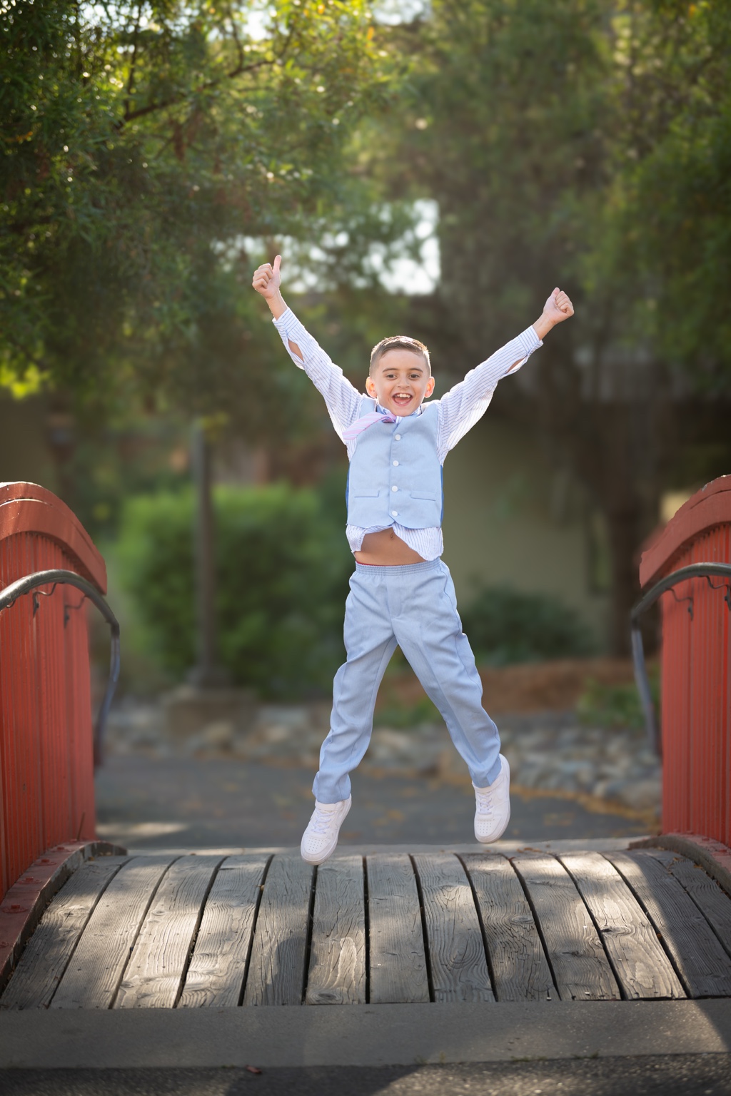 Tavi smiling and jumping on a wooden bridge